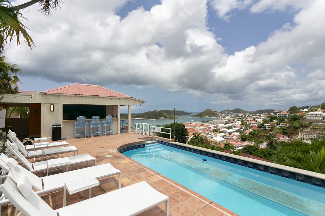 Pool, loungers and open-air bar overlooking Charlotte Amalie at The Mary Anne boutique hotel, St. Thomas