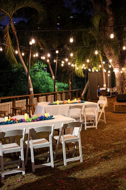 Caribbean wedding venues set with reception tables under string lights in a tropical garden in St. Thomas