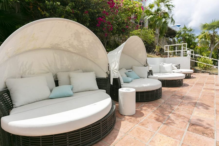 Round poolside daybeds with cushions and bougainvillea at The Mary Anne, a St. Thomas bachelorette party hotel
